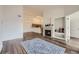 Spacious open-concept living area with wood floors, fireplace, and view to the kitchen at 12288 W Dorado Pl # 301, Littleton, CO 80127