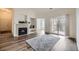 Light-filled living room featuring a cozy fireplace, an open layout, and balcony access at 12288 W Dorado Pl # 301, Littleton, CO 80127