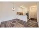 Open-concept living space with hardwood floors, a dining area, and a view of the kitchen at 12288 W Dorado Pl # 301, Littleton, CO 80127