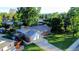 Aerial view of a charming brick home with a spacious yard and mature trees in a quiet neighborhood at 820 Cottonwood Ave, Centennial, CO 80121