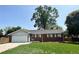 Charming brick home with a well-manicured lawn and attached garage at 820 Cottonwood Ave, Centennial, CO 80121
