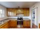 Updated kitchen with modern stove and oven with wood cabinetry at 820 Cottonwood Ave, Centennial, CO 80121