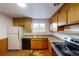 Well-lit kitchen with wood cabinets, laminate countertops, and stainless-steel appliances at 820 Cottonwood Ave, Centennial, CO 80121