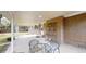 Covered patio area with brick wall, tile floor, seating, and space for outdoor dining at 820 Cottonwood Ave, Centennial, CO 80121