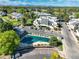 Aerial view featuring complex, pool, mature trees, landscaping, and mountain views at 1820 Newland Ct # 201, Lakewood, CO 80214