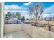 Balcony offering views of mature trees and a glimpse of the surrounding community at 1820 Newland Ct # 201, Lakewood, CO 80214