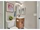 Compact bathroom with a wooden vanity, modern mirror, and tasteful decor at 1820 Newland Ct # 201, Lakewood, CO 80214