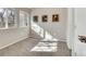Bright bedroom with three windows showcasing a view of trees and natural light at 1820 Newland Ct # 201, Lakewood, CO 80214