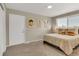 Relaxing bedroom featuring warm lighting, artwork, and carpet floors at 1820 Newland Ct # 201, Lakewood, CO 80214