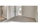 Bedroom entrance with carpet, open doors, and a view into a bright living room at 1820 Newland Ct # 201, Lakewood, CO 80214