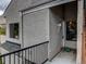 Inviting front entrance with neutral stucco, dark railing, and a welcoming door at 1820 Newland Ct # 201, Lakewood, CO 80214