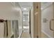 Hallway leading to a bedroom and bathroom with tiled floors and neutral walls at 1820 Newland Ct # 201, Lakewood, CO 80214