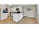 Well-lit kitchen with stainless steel appliances, white cabinets, and an island with seating at 1820 Newland Ct # 201, Lakewood, CO 80214