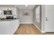 Bright kitchen with white cabinets, stainless steel appliances, and laminate wood flooring at 1820 Newland Ct # 201, Lakewood, CO 80214