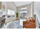 Bright living room featuring vaulted ceilings, a modern fireplace, and sliding glass doors to the outdoor at 1820 Newland Ct # 201, Lakewood, CO 80214