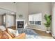 Cozy living room with a fireplace, large windows, and stylish decor at 1820 Newland Ct # 201, Lakewood, CO 80214