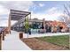 Modern restaurant exterior featuring large windows, an outdoor patio, and unique architectural design at 1820 Newland Ct # 201, Lakewood, CO 80214