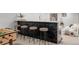 Basement bar features black brick, a marble countertop, seating for four and a foosball table at 5516 S Havana Ct, Englewood, CO 80111