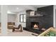 Basement rec room with brick fireplace, large window, and a foosball table for entertainment at 5516 S Havana Ct, Englewood, CO 80111