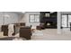 Basement seating area features modern decor, a fireplace with black brick, and large window at 5516 S Havana Ct, Englewood, CO 80111