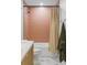 Elegant bathroom featuring a bathtub with peach tile, a shower curtain, and modern fixtures at 5516 S Havana Ct, Englewood, CO 80111