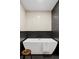 Modern bathroom featuring a sleek soaking tub, stylish tile work, and elegant fixtures at 5516 S Havana Ct, Englewood, CO 80111