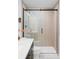 Contemporary bathroom featuring a glass-enclosed shower with sleek fixtures and wood-look tile at 5516 S Havana Ct, Englewood, CO 80111