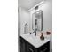 Well-lit bathroom features a modern vanity with marble countertop and sleek black hardware at 5516 S Havana Ct, Englewood, CO 80111