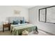Bright bedroom with a plaid headboard, cozy bedding, and natural light from a large window at 5516 S Havana Ct, Englewood, CO 80111