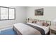 Modern bedroom with a large window, stylish furnishings, and a decorative horse art piece at 5516 S Havana Ct, Englewood, CO 80111