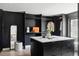 Spacious walk-in closet featuring an island with a marble countertop, dark cabinets, and ample storage at 5516 S Havana Ct, Englewood, CO 80111