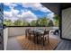 Spacious deck with outdoor dining set, ideal for enjoying meals with a scenic view of trees and blue skies at 5516 S Havana Ct, Englewood, CO 80111