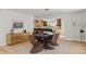 Open-concept dining room features modern light fixtures, a large table, and a serving buffet at 5516 S Havana Ct, Englewood, CO 80111