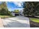 Long driveway leading to a well-maintained two-story home with a charming exterior and manicured landscaping at 5516 S Havana Ct, Englewood, CO 80111