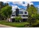 Modern home showcasing a sleek exterior, with lush landscaping, and beautiful trees creating a private atmosphere at 5516 S Havana Ct, Englewood, CO 80111