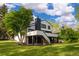 Landscaped view of the two-story home with a spacious yard and mature trees for a peaceful atmosphere at 5516 S Havana Ct, Englewood, CO 80111