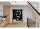 Hallway with staircase and built-in storage, leading to a room with a desk at 5516 S Havana Ct, Englewood, CO 80111