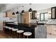 Modern kitchen featuring a large island, sleek countertops, modern appliances, and stylish pendant lighting at 5516 S Havana Ct, Englewood, CO 80111