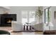 Bright living room features a fireplace, white armchairs, and glass doors to the outdoors at 5516 S Havana Ct, Englewood, CO 80111
