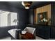 Modern office with dark walls, built-in storage, and a wooden desk, offering a sophisticated workspace at 5516 S Havana Ct, Englewood, CO 80111