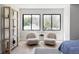 Cozy sitting area with two plush chairs, natural light from two windows, and stylish decor at 5516 S Havana Ct, Englewood, CO 80111