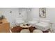 Basement sitting room showcases three white armchairs, a round table, and plush floor coverings at 5516 S Havana Ct, Englewood, CO 80111