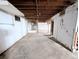 Wide shot of unfinished basement with concrete floors and white concrete walls at 11897 Roxburg St, Strasburg, CO 80136