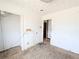 View of bedroom with peeling walls, open door, and exposed wires at 11897 Roxburg St, Strasburg, CO 80136