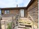 Welcoming entrance to the home with a traditional wooden porch and exterior details at 11897 Roxburg St, Strasburg, CO 80136