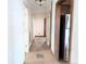 Hallway with tile flooring and multiple doorways, showcasing the home's layout at 11897 Roxburg St, Strasburg, CO 80136