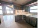 Spacious kitchen featuring an eating bar, ample countertops, and tile flooring at 11897 Roxburg St, Strasburg, CO 80136