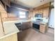 Functional kitchen equipped with stainless steel appliances and ample cabinet space at 11897 Roxburg St, Strasburg, CO 80136