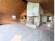 Open-concept living room showcasing tile flooring, a fireplace, and seamless connection to the kitchen area at 11897 Roxburg St, Strasburg, CO 80136