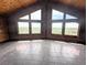 Spacious living room featuring large picture windows with scenic views and tile flooring at 11897 Roxburg St, Strasburg, CO 80136
